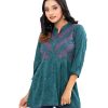 Green all-over printed A-line Top in Georgette fabric. Features a band neck with hook closure at the front and three-quarter sleeves. Pleats from the waistline.