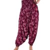 Burgundy all-over printed Harem pants in Viscose fabric. Designed with smoked waistline with adjustable tasseled waist cords and side packets.