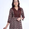 Chocolate all-over printed straight-cut Kameez in Georgette fabric. Features a V-neck with hook closure at the front and three-quarter sleeves. Detailed with embroidered net attachment at the top front. Embellished with swing stitched patch attachment at the neck and cuffs. Pleats from the waistline. Unlined.