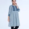 White A-line Tunic in printed Georgette fabric. Features a band neck with hook closure at the front and three-quarter sleeves. Embellished with embroidery at the top front and gathers from the waistline. Patch attachment at the sleeves. Unlined.