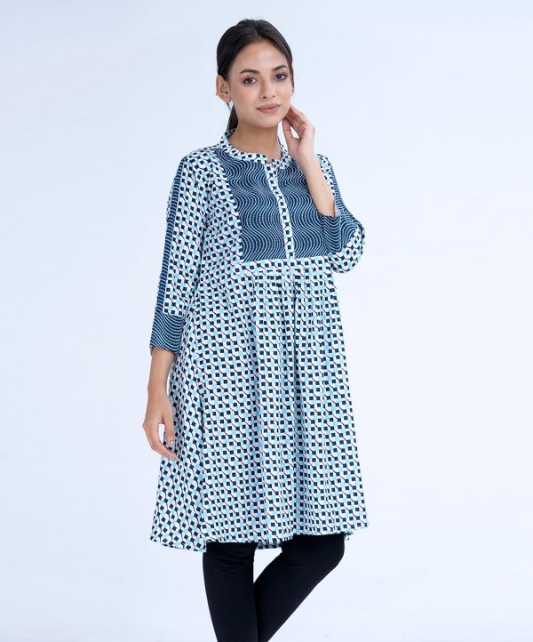 White A-line Tunic in printed Georgette fabric. Features a band neck with hook closure at the front and three-quarter sleeves. Embellished with embroidery at the top front and gathers from the waistline. Patch attachment at the sleeves. Unlined.