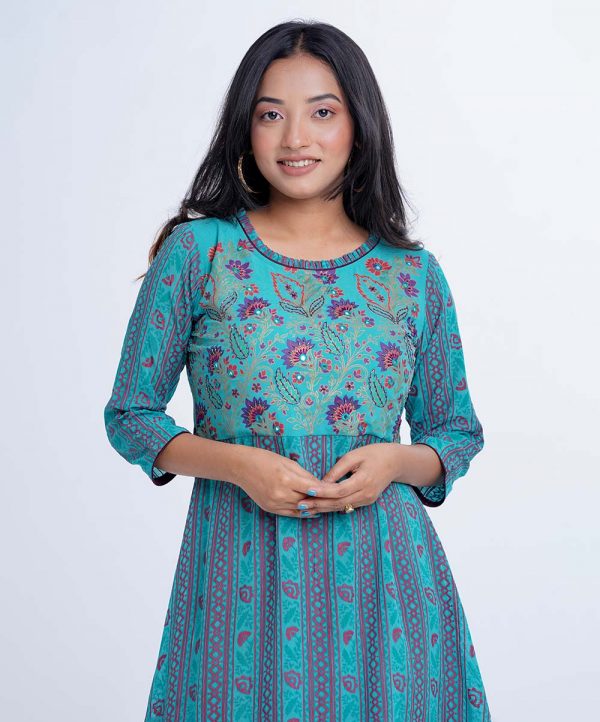 Blue all-over printed A-line Tunic in Georgette fabric. Designed with a round neck and three-quarter sleeves. Embellished with karchupi at the top front.