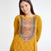 Yellow all-over printed long Tunic in Viscose fabric. Designed with a boat neck and three-quarter sleeves. Embellished with karchupi and patch attachment at the top front. Plates from the waistline and elongated hemline. Single button opening at the back.