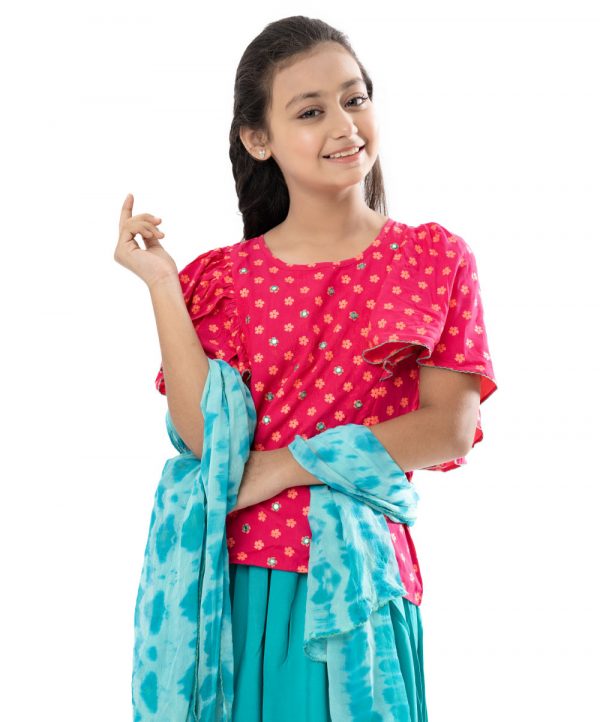 Magenta and Turquoise all-over printed Ghagra-choli set in Viscose fabric. The top is designed with a round neck and butterfly sleeves. Embellished embroidery at the top front. Button opening at the back. Paired with the gathered skirt with a concealed elasticated waistline. Spliced gather hemline. Complemented with tie-dye chiffon dupatta.