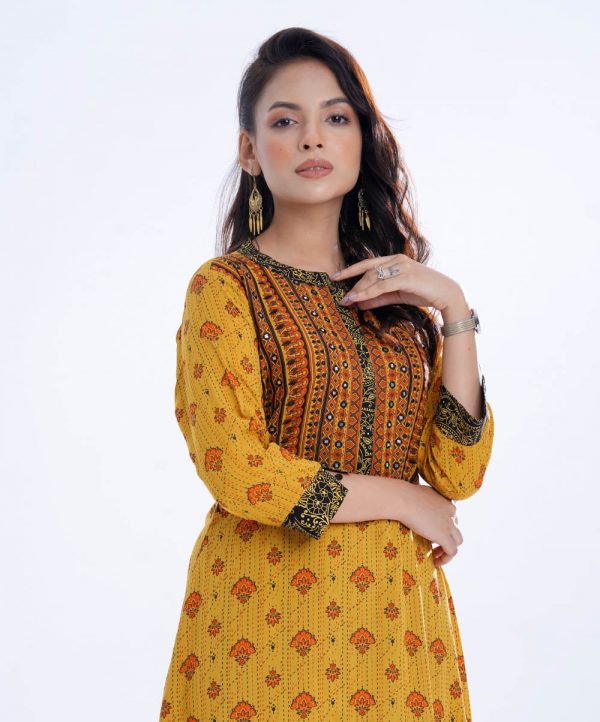 Yellow all-over printed A-line Tunic in Viscose fabric. Designed with a band neck and three-quarter sleeves. Embellished with embroidery at the front and back. Elongated hemline.