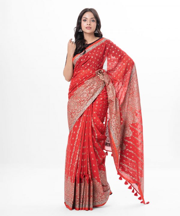 Red all-over printed Saree in Cotton fabric. Embellished with decorative tassels on the achal.