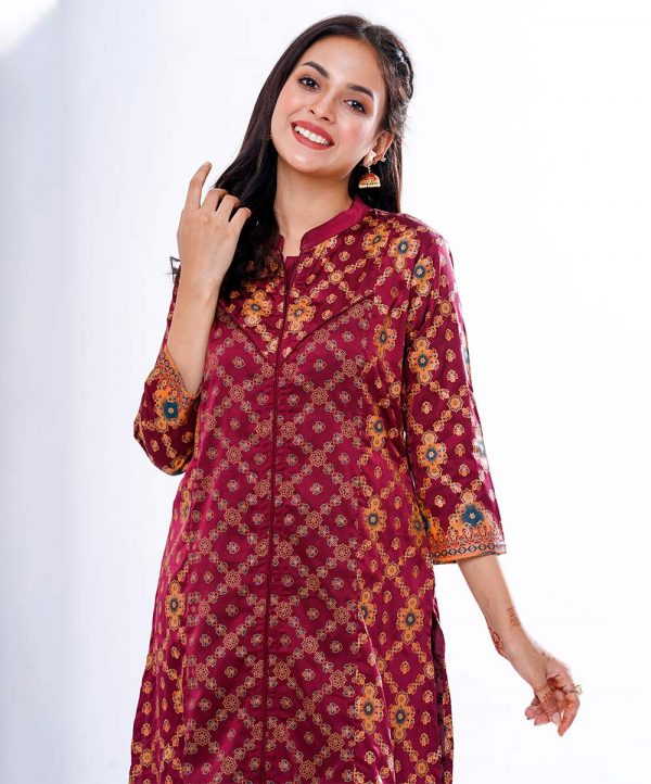 Marron all-over printed A-line Kameez in crepe fabric. Features a band neck with hook closure at the front and three-quarter sleeves. Designed with cut and sew at the front.