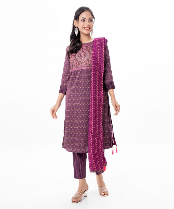 Purple all-over printed Salwar Kameez in Crepe fabric. The Kameez is designed with a round neck and three-quarter sleeves. Embellished with embroidery at the top front and wave tucks at the cuffs. Complemented by all-over printed culottes pants and a half-silk dupatta.