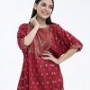 Red all-over printed A-line Tunic in Viscose fabric. Designed with a round neck and dropped sleeves. Embellished with karchupi at the top front. Gathers from the waistline. Single button opening at the back.