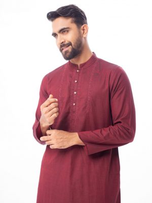 Maroon premium Panjabi in Cotton fabric. Designed with a mandarin collar and matching metal buttons on the placket. Embellished with karchupi at the top front.