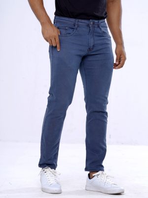 Men's slim fitted jeans in cotton spandex denim fabric. Five pockets, button fastening on the front and zipper fly.