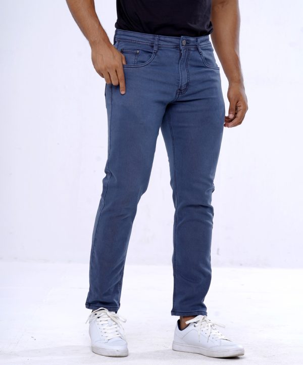 Men's slim fitted jeans in cotton spandex denim fabric. Five pockets, button fastening on the front and zipper fly.