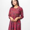 Maroon all-over printed patterned Gown in Georgette fabric. Designed with a round neck and three-quarter sleeves. Embellished with swing stitch at the top front. Single button opening at the back. Unlined.