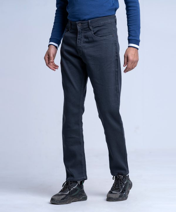 Men's slim fitted jeans in cotton spandex denim fabric. Five pockets, button fastening on the front and zipper fly.