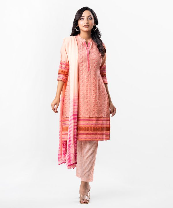 Peach all-over printed Salwar Kameez in Cotton-blend and Viscose fabric. The Kameez is designed with a round neck and three-quarter sleeves. Embellished printed patch attachment at the front. Complemented by palazzo pants and a chiffon dupatta.