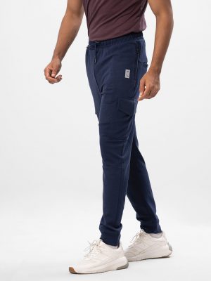 Navy Blue Trousers in interlock Cotton blend fabric. Designed with elasticized waistband with adjustable drawstring and side pockets with zipper. Leg pockets with flap.