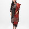 Black all-over printed Salwar Kameez in Viscose fabric. The Kameez is designed with a round neck and three-quarter sleeves. Embellished with karchupi at the top front. Complemented by culottes pants with print on the border lines and a half-silk dupatta.