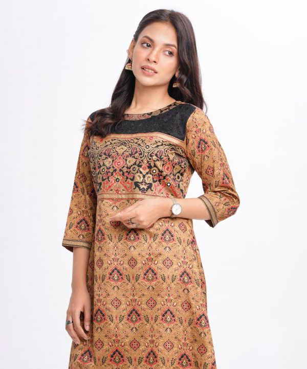 Brown all-over printed A-line Kameez in Crepe fabric. Designed with a low mock neck and three-quarter sleeves. Sequined net details and karchupi at the top front. Printed patch attachment at the cuffs. Single button opening at back.