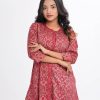 Garnet pink all-over printed A-line long Tunic in Velvet finish Georgette fabric. Features a low mock neck with a front button opening and three-quarter sleeves. Embellished with karchupi at the front and cuffs. Unlined.