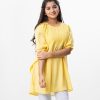 Yellow kaftan style Tunic in Georgette fabric. Designed with a round neck and bat sleeves. Embellished with karchupi at the top front and gathers from the waistline. Single button opening at the back. Viscose lining in half-body.