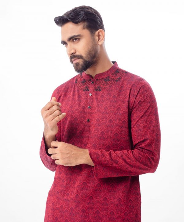 Maroon semi-fitted Panjabi in Jacquard Cotton fabric. Designed with a mandarin collar and matching metal buttons on the placket. Embellished with karchupi at the top front.