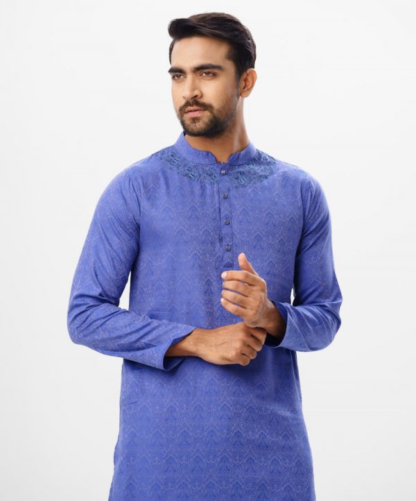 Blue semi-fitted Panjabi in Jacquard Cotton fabric. Designed with a mandarin collar and matching metal buttons on the placket. Embellished with karchupi at the top front.