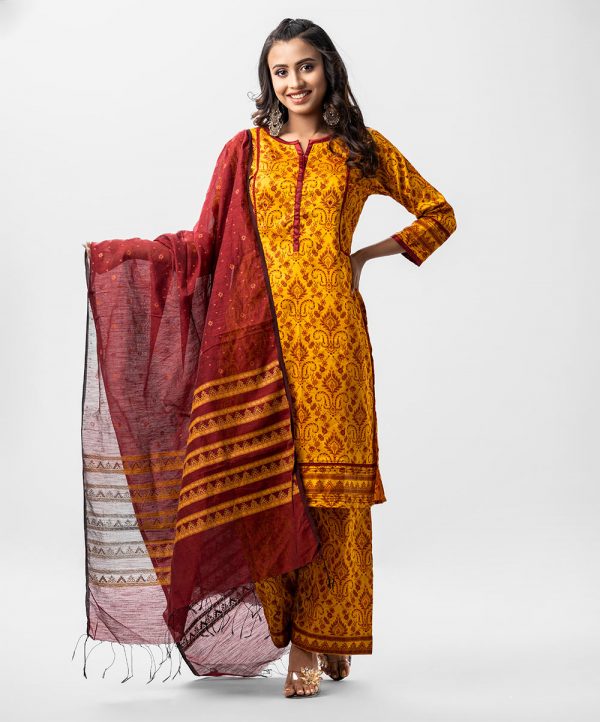 Printed salwar kameez in crepe fabric. Patch work on neck, placket and sleeves. Lace and pleat work at the front and sleeves. Half-silk dupatta with palazzo pants.