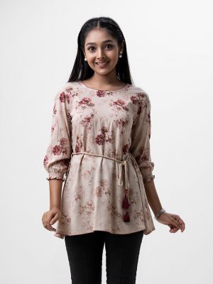 Bishop sleeved, teen girls floral printed A-line tunic in viscose fabric. Braided tassel ties at waist and karchupi at front.