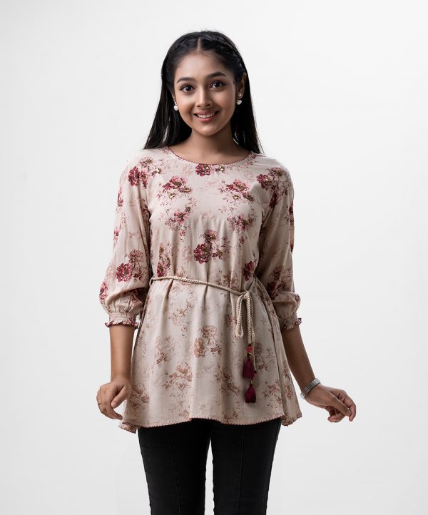 Bishop sleeved, teen girls floral printed A-line tunic in viscose fabric. Braided tassel ties at waist and karchupi at front.