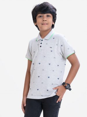 Kid boys short sleeves polo shirt in cotton pique fabric. Polka dot style tennis rackets printed.